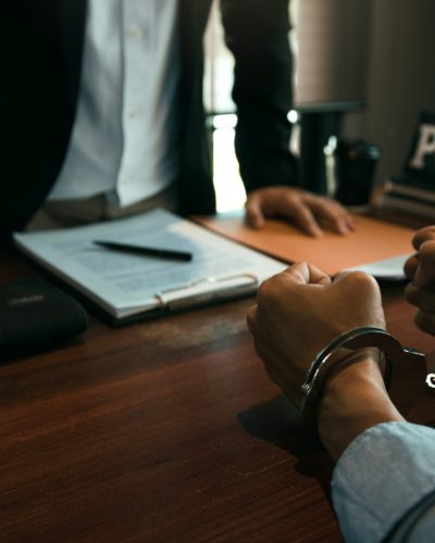 Police officers stand to make allegations about cyberbullying offenses at office room.